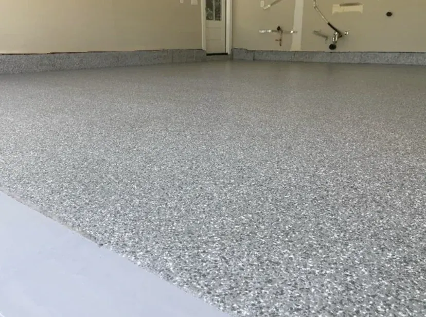 Close-up of a gray and white flake garage floor finish