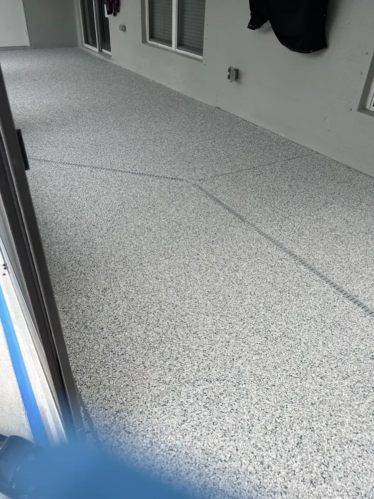 Gray decorative flake finish along the wall and doorway of a lanai