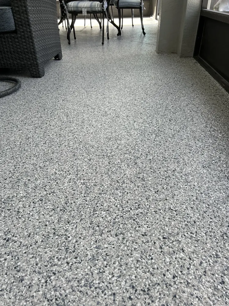 Decorative flake coating beneath furniture on a screened patio
